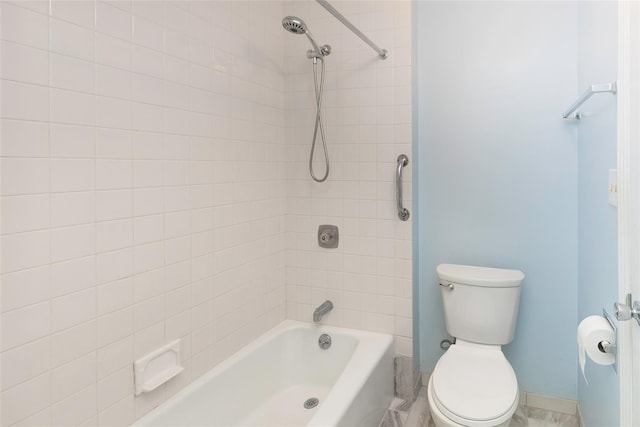 bathroom featuring tiled shower / bath and toilet