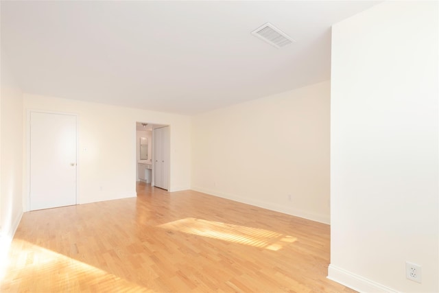 unfurnished room with light wood-type flooring