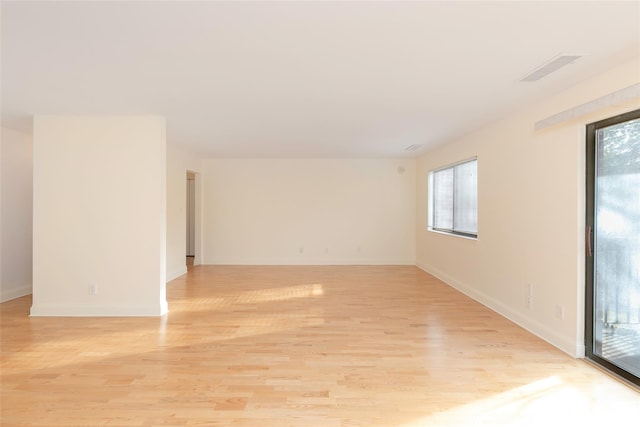 unfurnished room with light hardwood / wood-style flooring and a healthy amount of sunlight