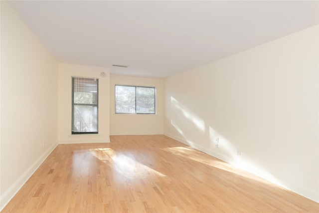 spare room with light hardwood / wood-style flooring