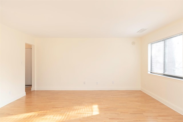 spare room featuring light hardwood / wood-style floors