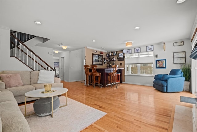 living room with hardwood / wood-style flooring and indoor bar