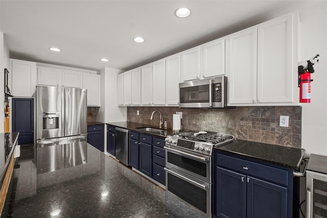 kitchen with dark stone countertops, sink, white cabinets, and appliances with stainless steel finishes