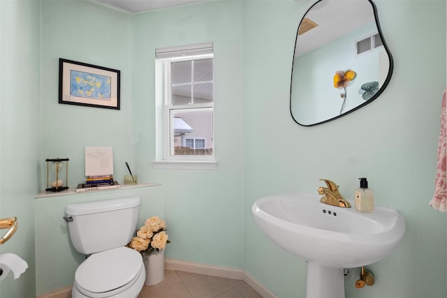 bathroom with sink, toilet, and tile patterned flooring