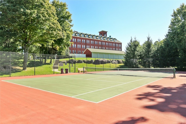 view of tennis court featuring basketball hoop