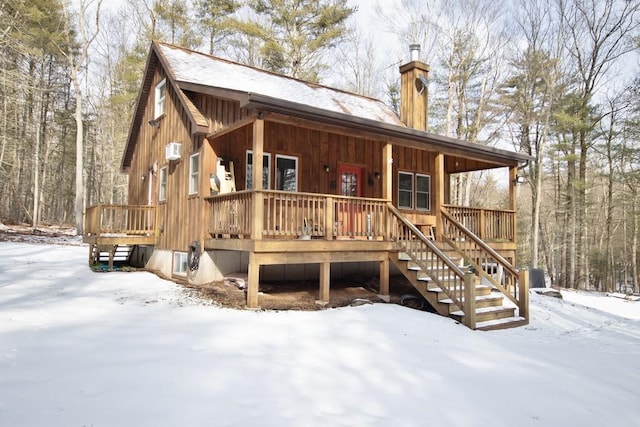 snow covered house with a porch