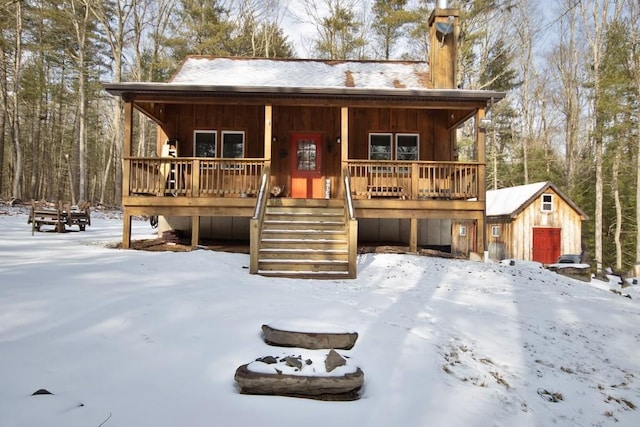 view of front facade featuring a storage unit and covered porch