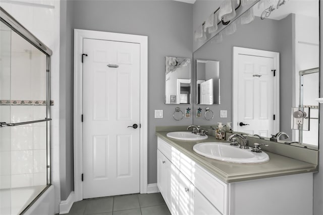 bathroom featuring vanity, tile patterned floors, and enclosed tub / shower combo