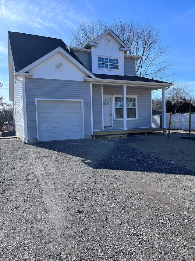 view of front property with a garage and a porch