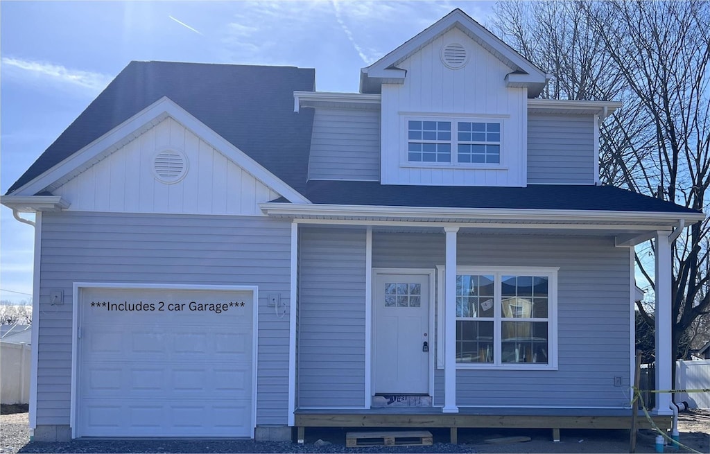 view of front facade with a garage and a porch