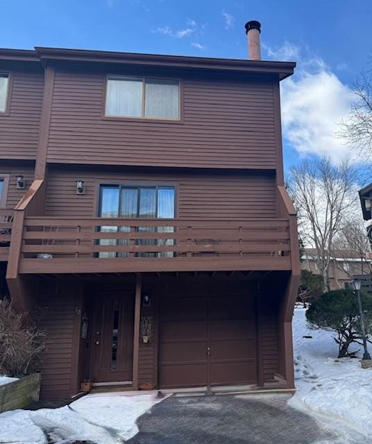 view of front facade with a deck and a garage