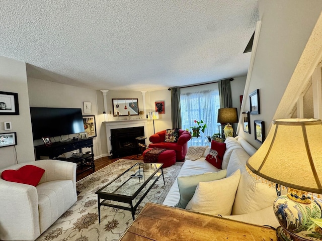 living room with light hardwood / wood-style flooring and a textured ceiling