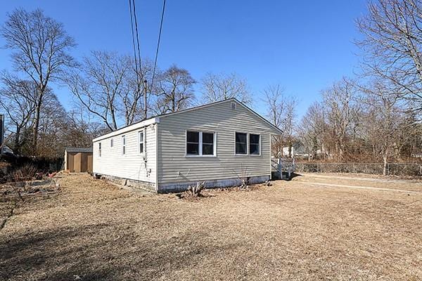 view of side of home with fence