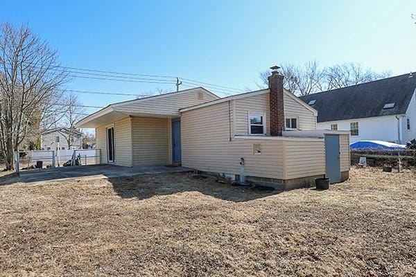 back of property with a chimney