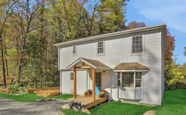 view of front property featuring a deck and a front yard