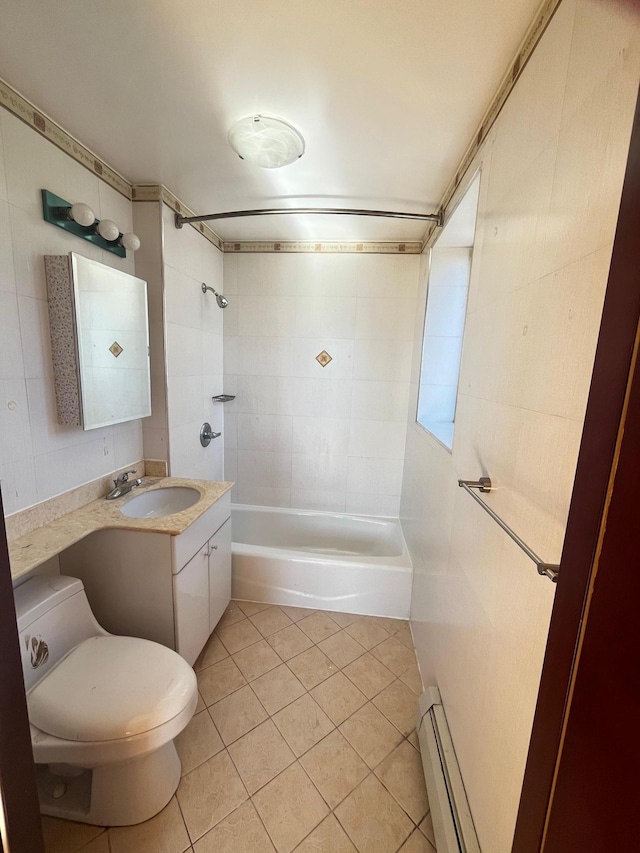 full bathroom featuring toilet, baseboard heating, vanity, tiled shower / bath combo, and tile patterned flooring