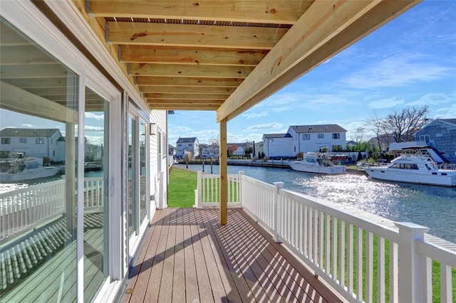 balcony featuring a deck with water view