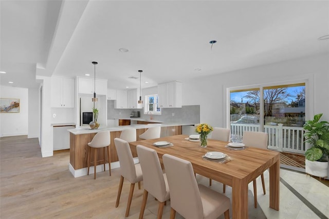 dining room featuring sink and light wood-type flooring