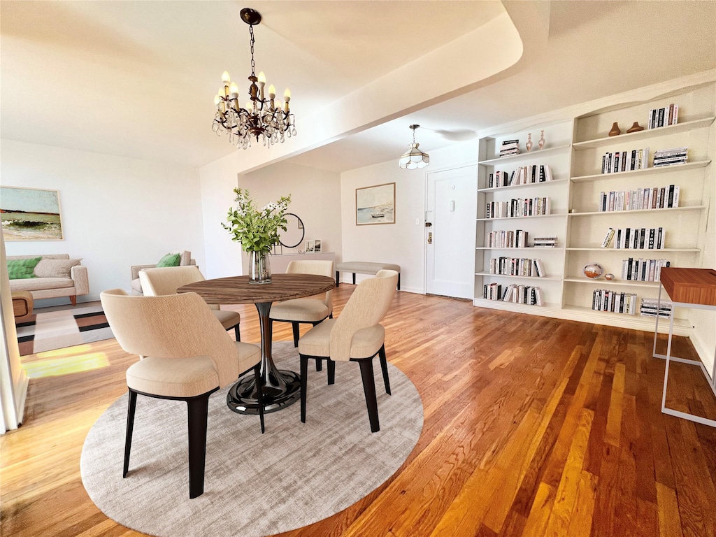 dining area featuring a notable chandelier and wood-type flooring