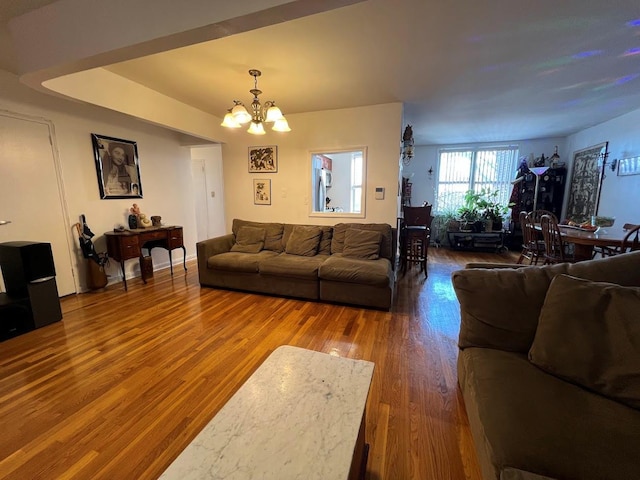 living room featuring an inviting chandelier and wood finished floors