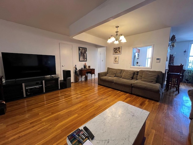 living room featuring a chandelier and wood finished floors