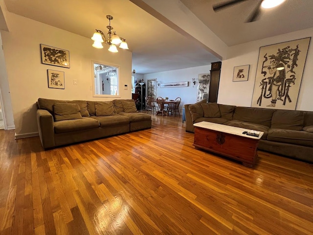 living room featuring hardwood / wood-style floors and ceiling fan with notable chandelier