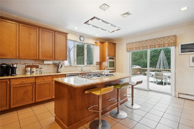 kitchen featuring backsplash, light stone countertops, an island with sink, and light tile patterned floors