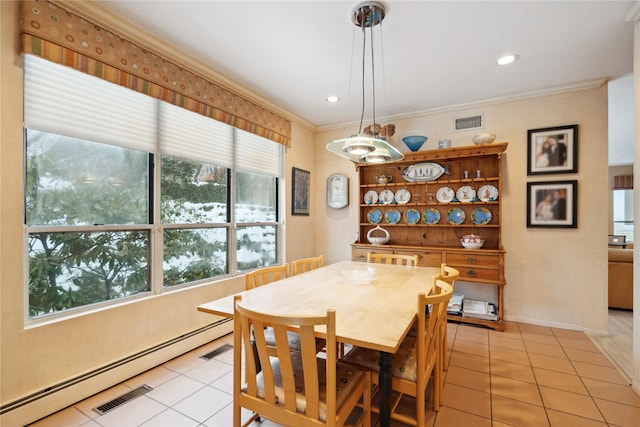 dining area featuring ornamental molding, a baseboard heating unit, and light tile patterned floors