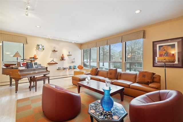 living room with hardwood / wood-style floors, track lighting, and a baseboard radiator