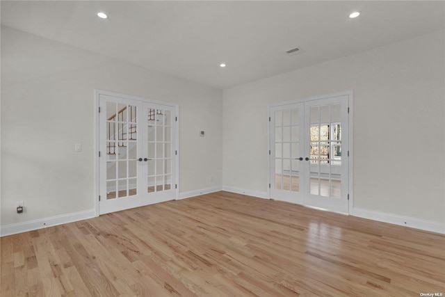 unfurnished room with french doors and light hardwood / wood-style floors