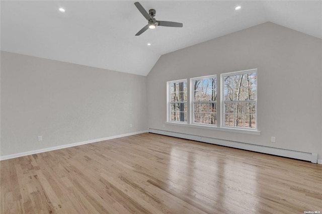 additional living space with lofted ceiling, a baseboard radiator, ceiling fan, and light wood-type flooring