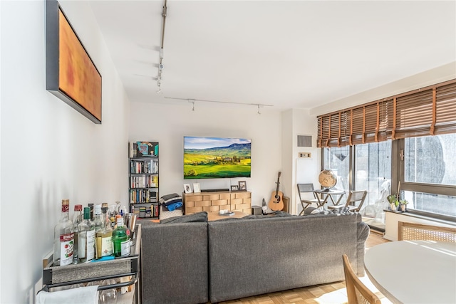 living room with rail lighting and visible vents