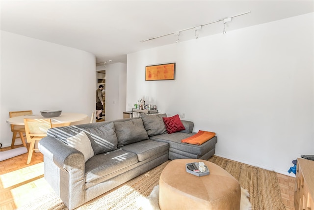 living room with rail lighting and baseboards