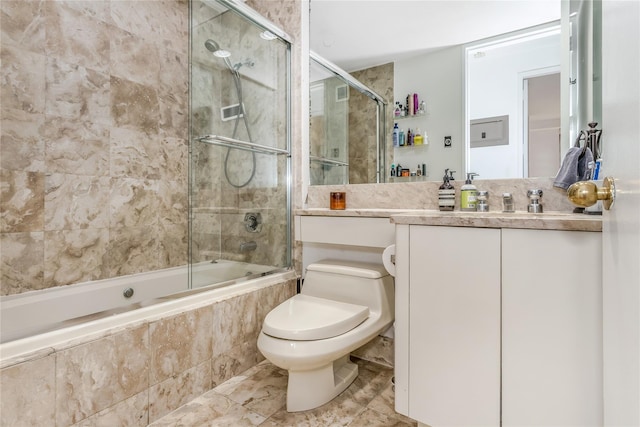 bathroom featuring toilet, vanity, and tiled shower / bath combo