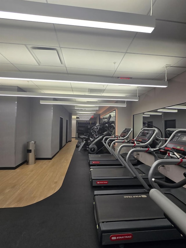 exercise room featuring light wood-style floors