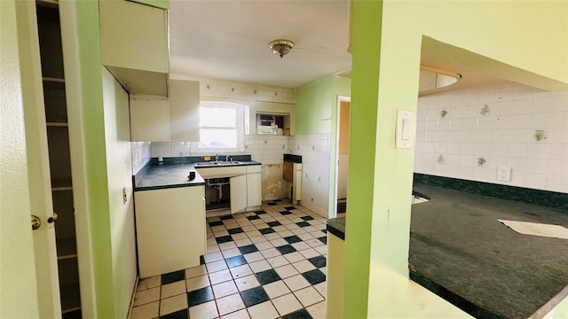 kitchen featuring tile walls, sink, and backsplash