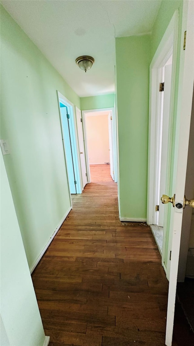 hallway with dark wood-type flooring