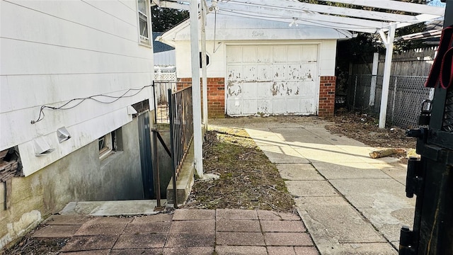 exterior space with a garage and an outbuilding