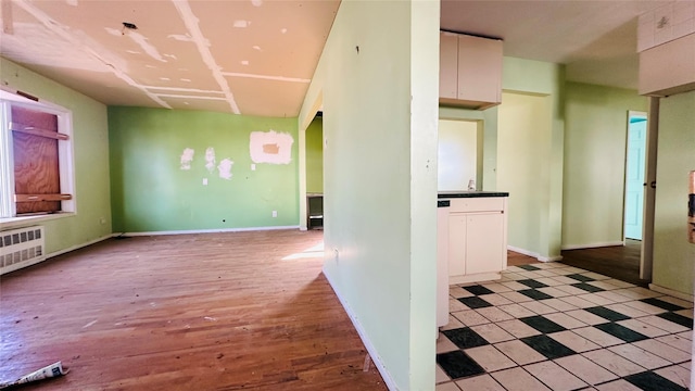 interior space with radiator and light hardwood / wood-style floors