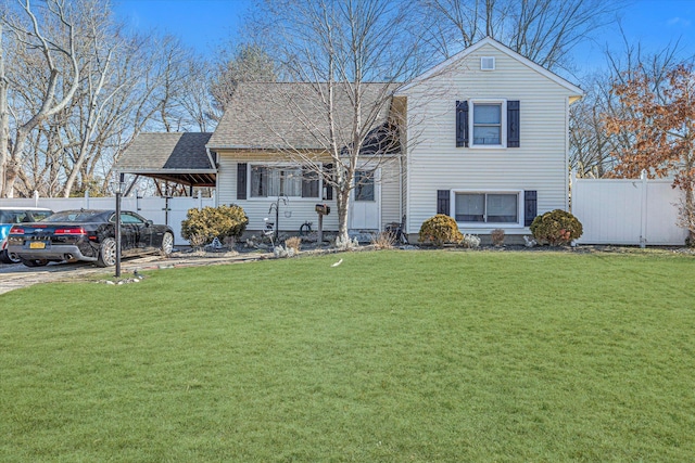 view of front facade featuring a shingled roof, fence, a front lawn, and a carport