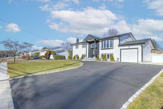 view of front of home with a garage and a front yard