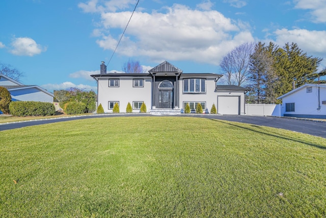 view of front of property with a garage and a front yard