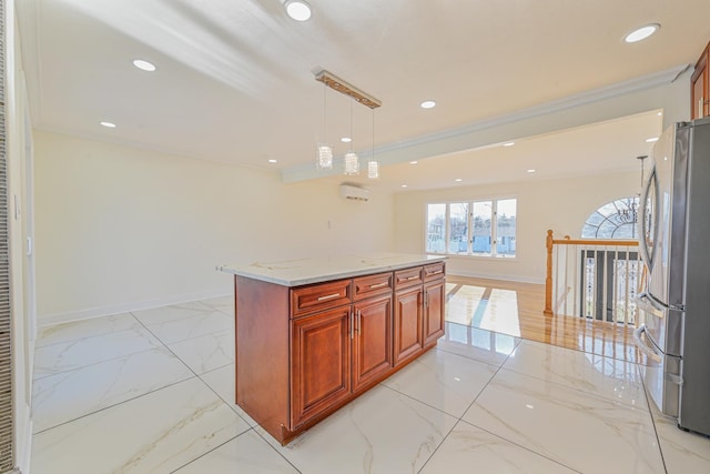 kitchen featuring stainless steel refrigerator, light stone counters, ornamental molding, a kitchen island, and decorative light fixtures