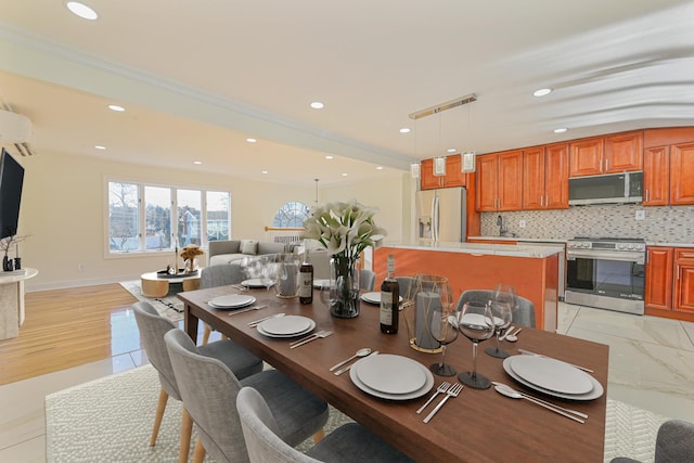 dining room featuring ornamental molding, sink, and a wall mounted air conditioner