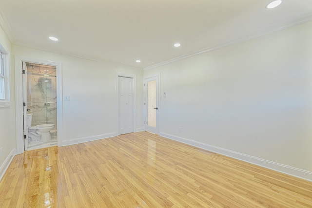 unfurnished room featuring crown molding and light wood-type flooring