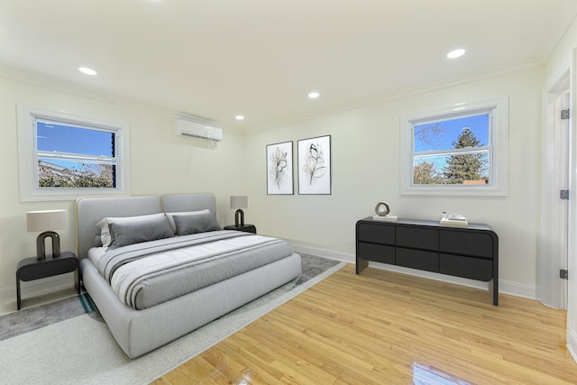 bedroom featuring a wall mounted air conditioner, ornamental molding, and hardwood / wood-style floors