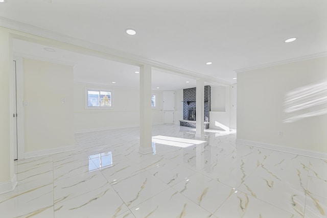 empty room featuring crown molding and a fireplace