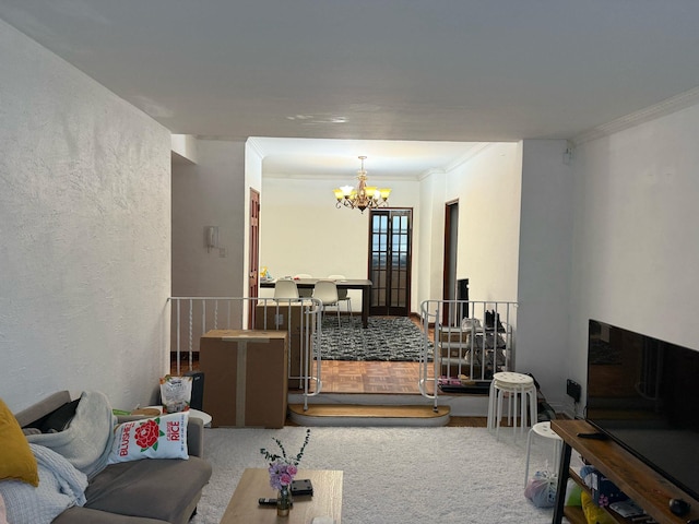 living area with a chandelier and crown molding