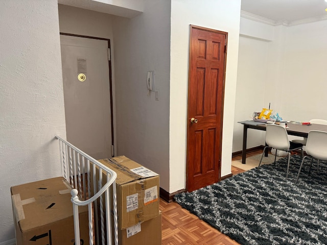 interior space with crown molding and baseboards