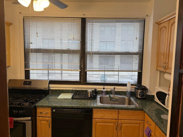 kitchen featuring white microwave, a sink, black dishwasher, dark countertops, and gas range